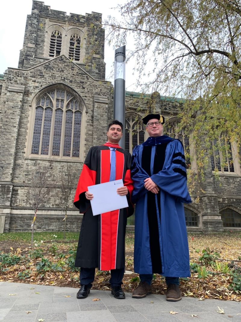 Dr. Serdar San and Professor Matt Light in robes, Nov. 7 2023 convocation 