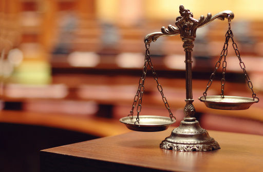 an image of brass scales on a wooden table