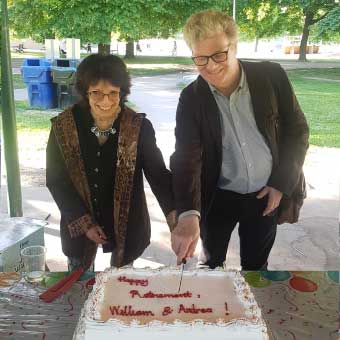 Andrea Shier and William Watson cutting a celebratory cake together at Christie Pits Park.