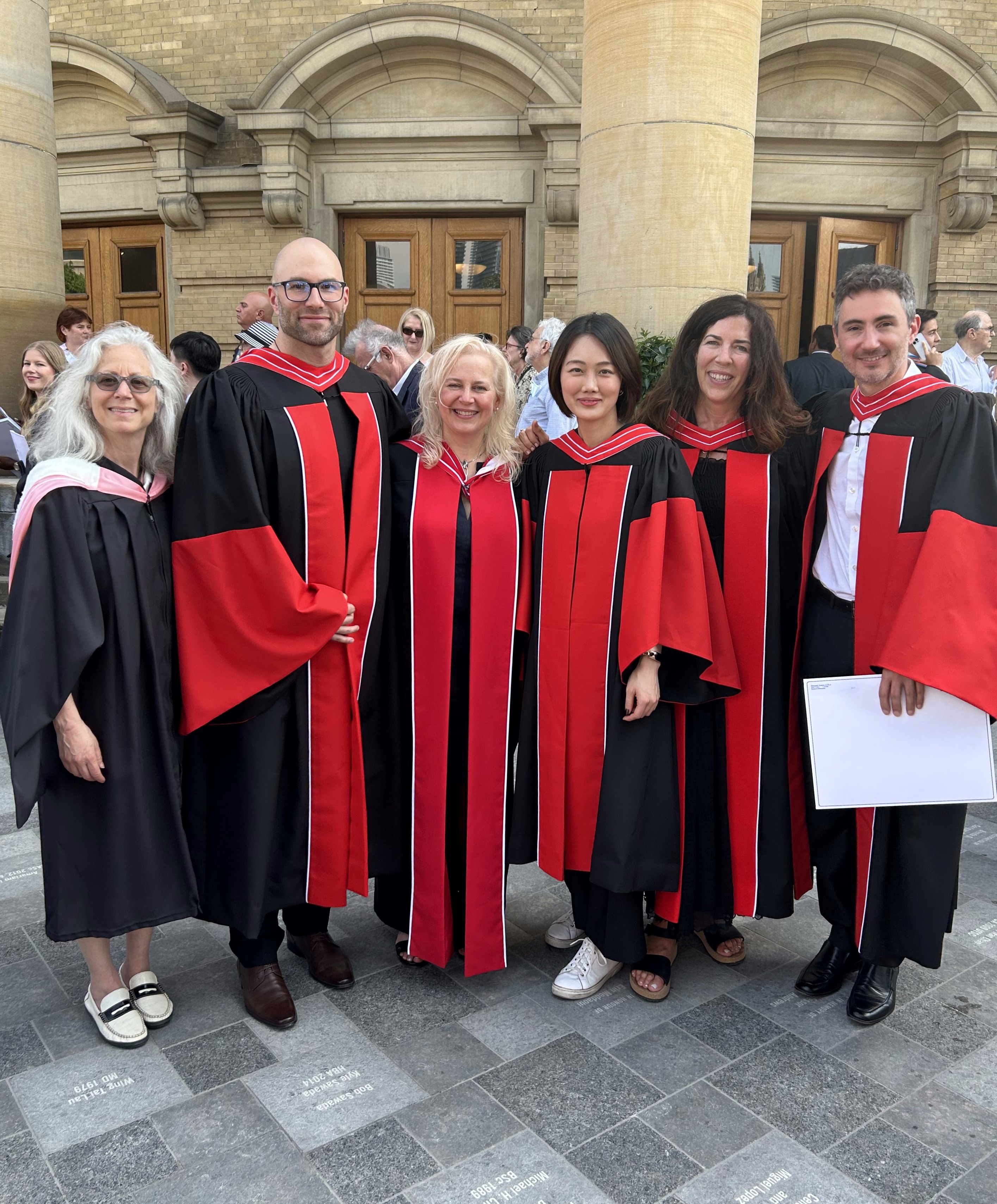 Convocation Day! Newly minted CrimSL PhDs and their supervisors gather proudly outside Convocation Hall, June 2, 2023.(L-R): Professor Audrey Macklin, Director, Centre for Criminology and Sociolegal Studies; Dr. Grant Valentine; Professor Paula Maurutto; 