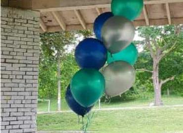 blue, teal, and silver balloons in a park