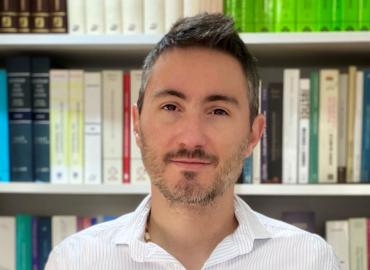 head shot of Dr. Fernando Avila in front of bookshelf