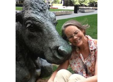 Liz Ukrainetz head to head with sculpture of cow at Wellington W and Bay Streets, Toronto (The Pasture by Joe Fafard, 1985)